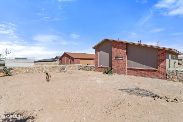 exterior space featuring brick siding
