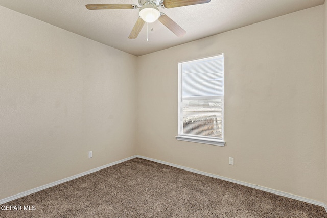 empty room with baseboards, ceiling fan, and carpet flooring
