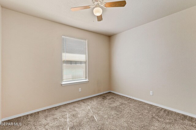 unfurnished room featuring baseboards, carpet flooring, and a ceiling fan