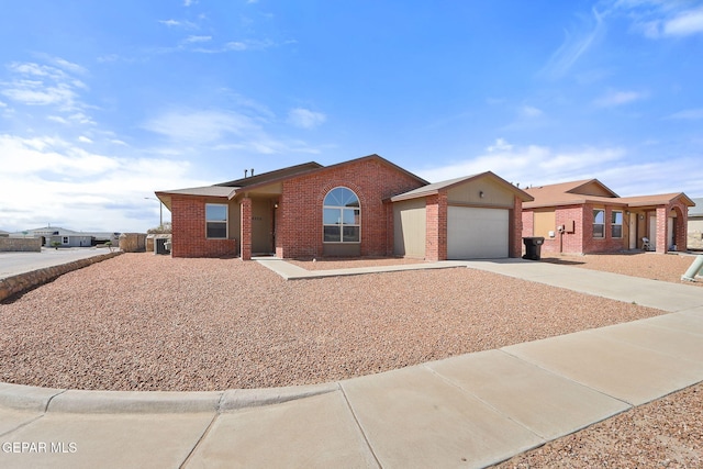 ranch-style house featuring brick siding, an attached garage, and driveway