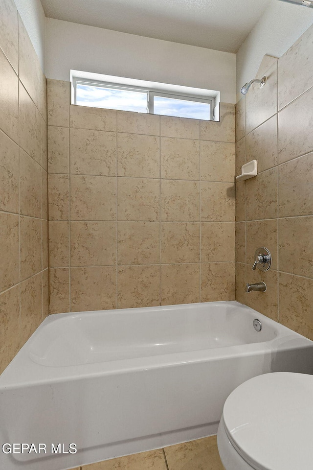 bathroom with shower / bathtub combination and toilet