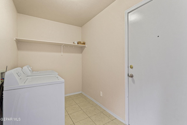 laundry area featuring light tile patterned floors, baseboards, laundry area, and independent washer and dryer