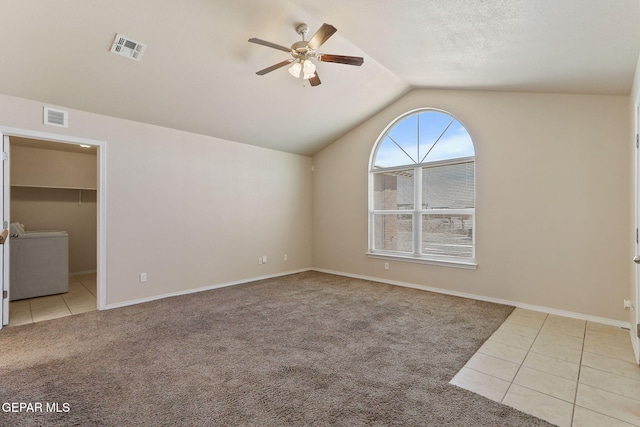 interior space with tile patterned flooring, ceiling fan, washer / clothes dryer, and visible vents