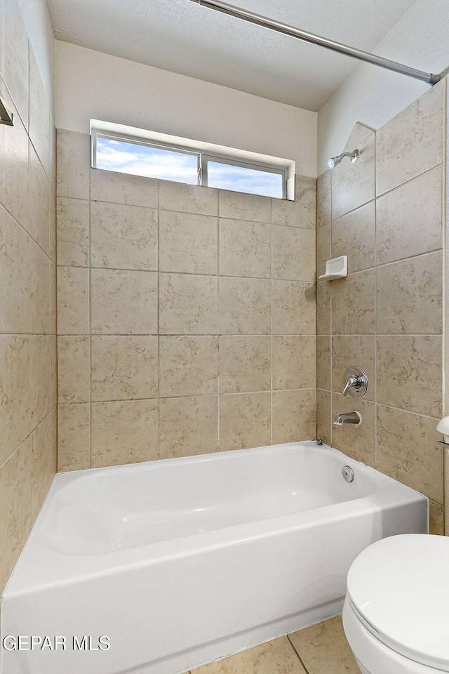 full bathroom with shower / bathing tub combination, tile patterned floors, and toilet