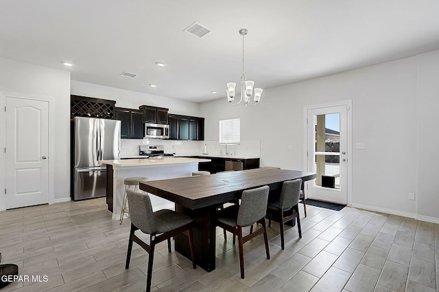 dining space featuring visible vents, recessed lighting, baseboards, and a notable chandelier