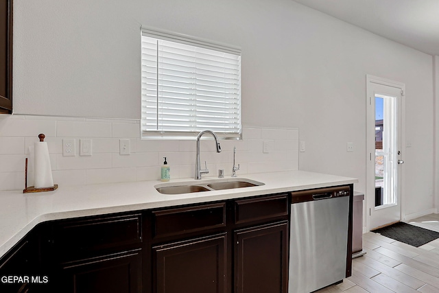 kitchen featuring a sink, light countertops, dark brown cabinetry, and dishwasher