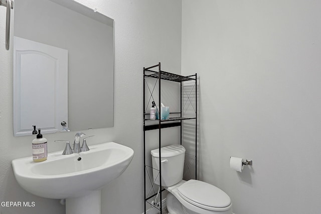 bathroom featuring toilet and a sink