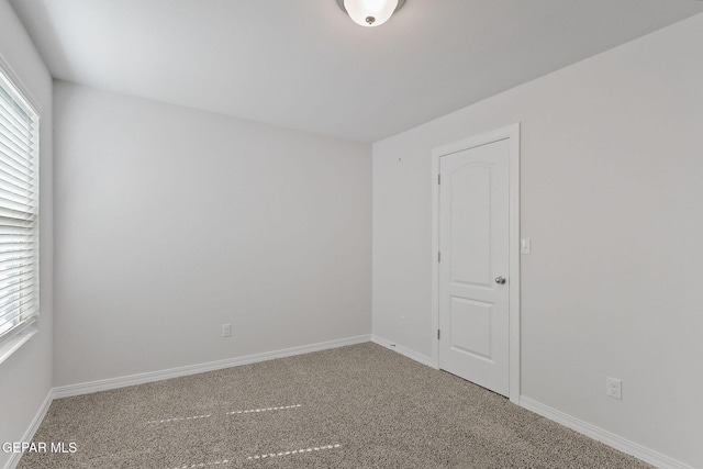 spare room with carpet floors and baseboards
