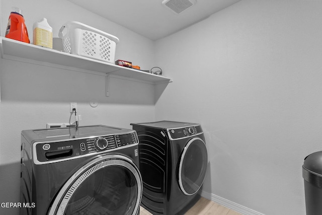 laundry room featuring laundry area, baseboards, washer and dryer, and visible vents