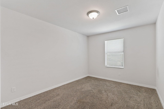 carpeted empty room with baseboards and visible vents