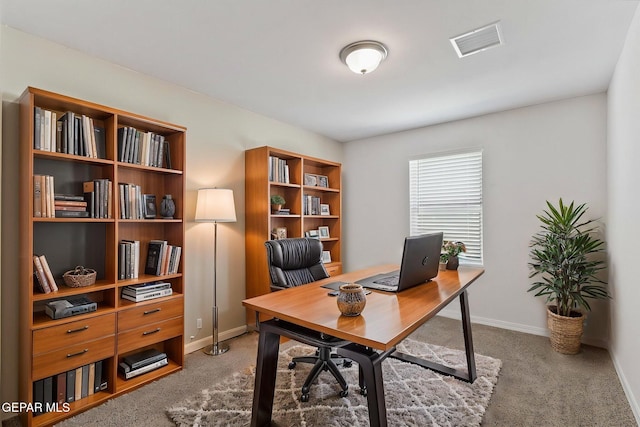 office area with light colored carpet, baseboards, and visible vents