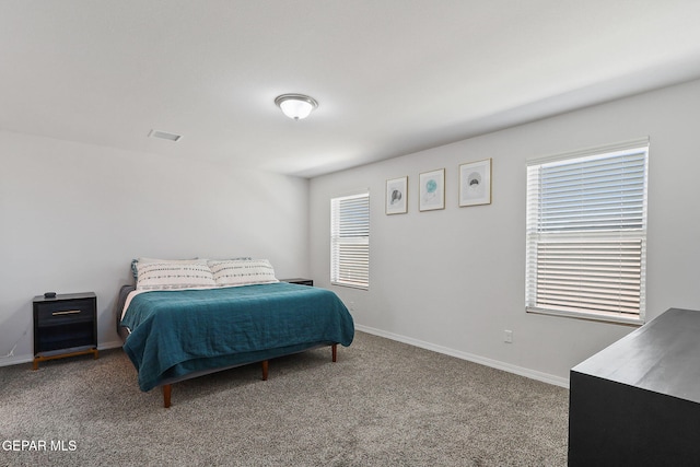 bedroom featuring carpet floors and baseboards