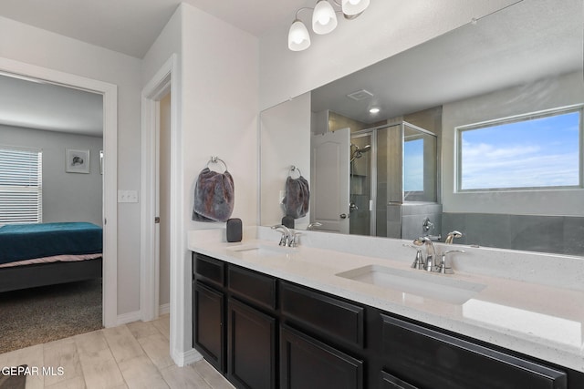 bathroom with a sink, a stall shower, double vanity, and visible vents