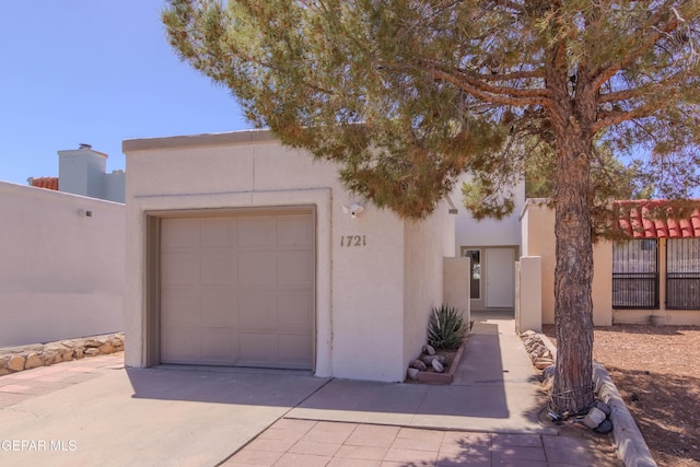 1721 Villa Santos Cir, El Paso, TX 79935 - southwest-style home with fence, an attached garage, driveway, and stucco siding