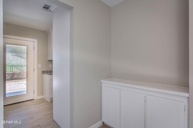 1721 Villa Santos Cir, El Paso, TX 79935 - hallway with baseboards, light wood finished floors, and visible vents