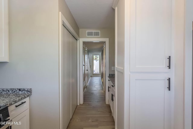 1721 Villa Santos Cir, El Paso, TX 79935 - corridor featuring light wood-type flooring and visible vents