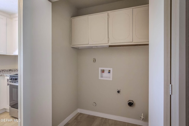 1721 Villa Santos Cir, El Paso, TX 79935 - laundry area with gas dryer hookup, electric dryer hookup, baseboards, hookup for a washing machine, and light wood-style flooring