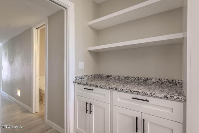 1721 Villa Santos Cir, El Paso, TX 79935 - bar with baseboards and light wood-style floors