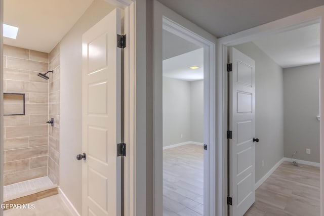 1721 Villa Santos Cir, El Paso, TX 79935 - full bath with baseboards, wood finished floors, and tiled shower