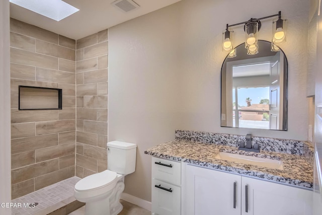 1721 Villa Santos Cir, El Paso, TX 79935 - bathroom with vanity, toilet, a skylight, visible vents, and tiled shower