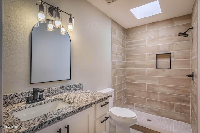 1721 Villa Santos Cir, El Paso, TX 79935 - full bath featuring toilet, a skylight, a tile shower, and vanity