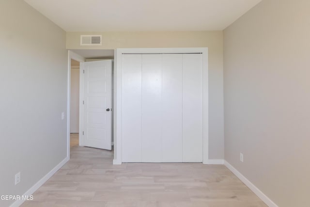 1721 Villa Santos Cir, El Paso, TX 79935 - unfurnished bedroom with light wood-style floors, baseboards, a closet, and visible vents