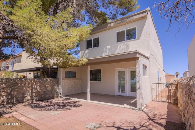 1721 Villa Santos Cir, El Paso, TX 79935 - rear view of house with a patio, stucco siding, french doors, and fence