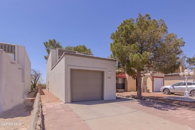 1721 Villa Santos Cir, El Paso, TX 79935 - view of front of house with a garage, stucco siding, and driveway