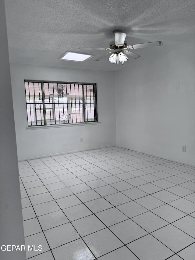 spare room with a textured ceiling and a ceiling fan