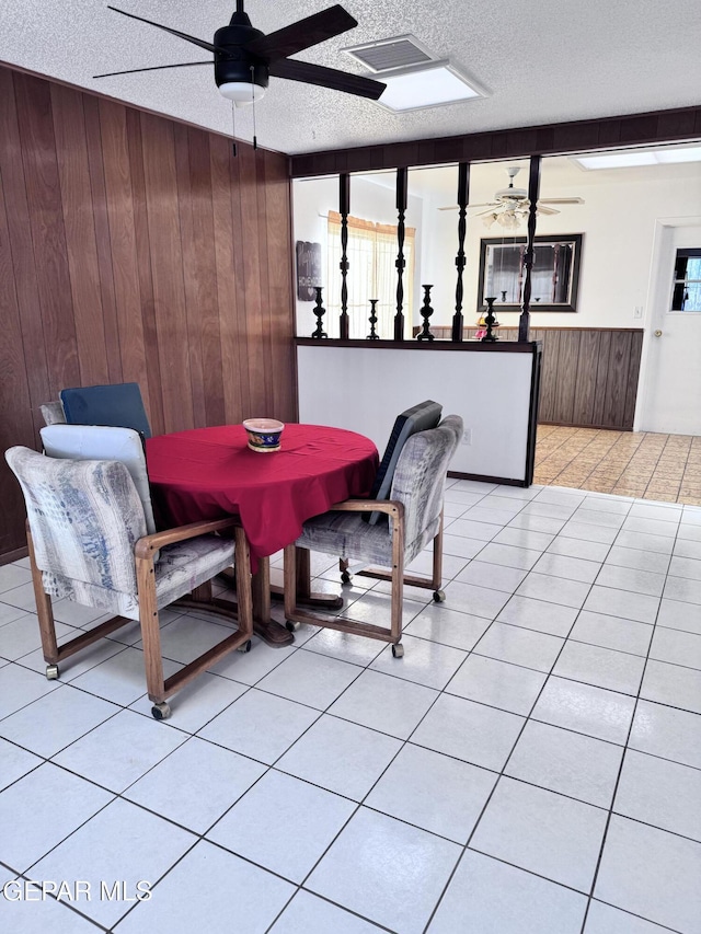 10304 Blackwood Ave, El Paso, TX 79925 - dining area with ceiling fan, wood walls, a wainscoted wall, and a textured ceiling