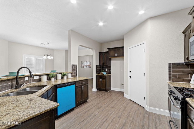 kitchen with dark brown cabinets, tasteful backsplash, a sink, dishwasher, and gas stove