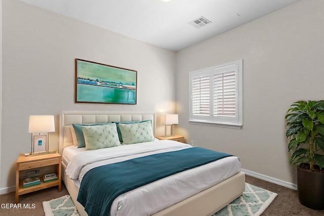 carpeted bedroom featuring baseboards and visible vents
