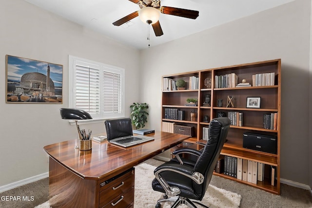 office space featuring baseboards, ceiling fan, and carpet flooring