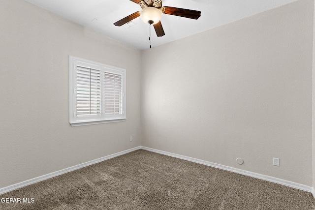 carpeted spare room featuring baseboards, ceiling fan, and visible vents