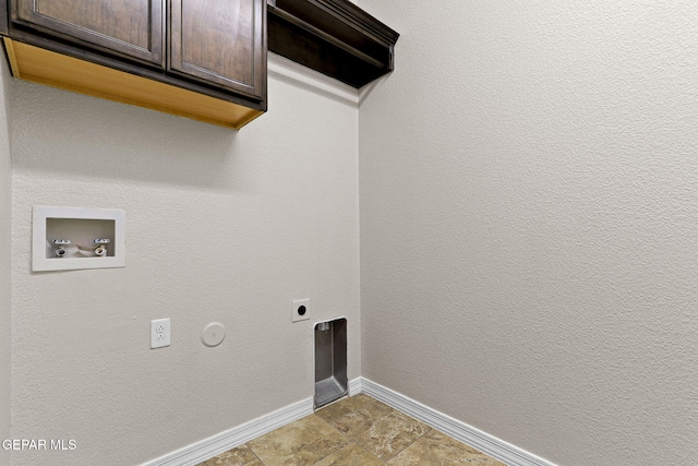 laundry area featuring electric dryer hookup, hookup for a washing machine, baseboards, and cabinet space