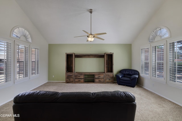 living room with plenty of natural light, a ceiling fan, and carpet flooring