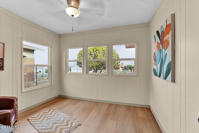 2723 Grant Ave, El Paso, TX 79930 - unfurnished room featuring light wood-style floors, baseboards, a textured ceiling, and a ceiling fan