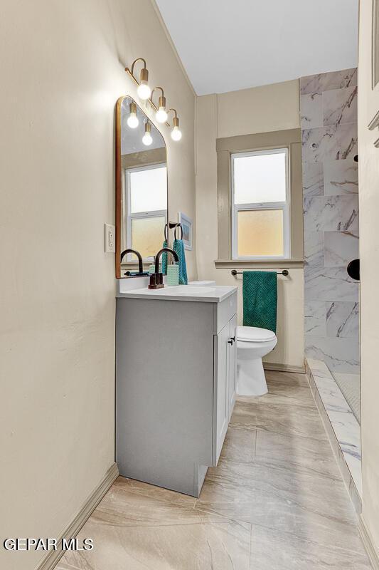 2723 Grant Ave, El Paso, TX 79930 - bathroom with toilet, healthy amount of natural light, vanity, and a shower