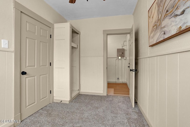 2723 Grant Ave, El Paso, TX 79930 - unfurnished bedroom featuring carpet floors, electric panel, wainscoting, and a decorative wall
