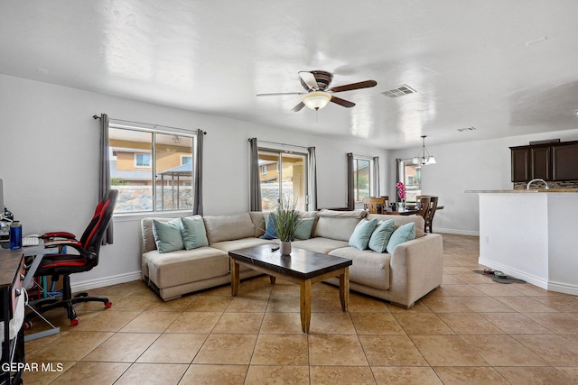 2709 Granite Rock Pl, El Paso, TX 79938 - living area with baseboards, visible vents, light tile patterned floors, and ceiling fan with notable chandelier