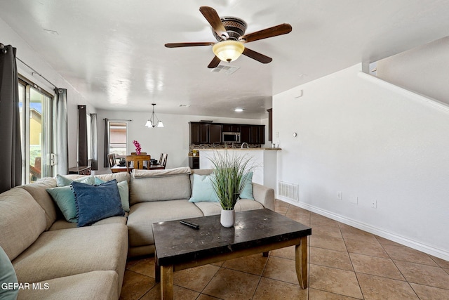 2709 Granite Rock Pl, El Paso, TX 79938 - living room featuring baseboards, ceiling fan with notable chandelier, light tile patterned flooring, and visible vents