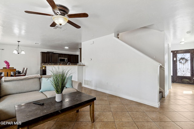 2709 Granite Rock Pl, El Paso, TX 79938 - living area with stairway, light tile patterned floors, a ceiling fan, and visible vents