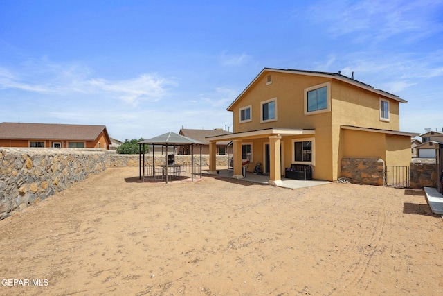 2709 Granite Rock Pl, El Paso, TX 79938 - back of house featuring a patio, a gazebo, a fenced backyard, and stucco siding