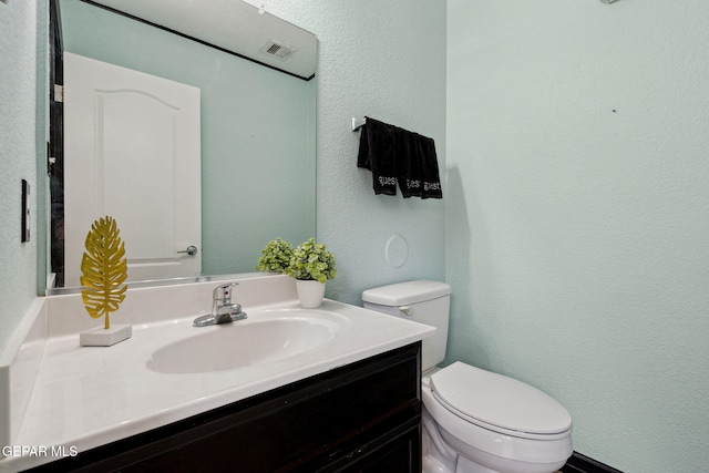 2709 Granite Rock Pl, El Paso, TX 79938 - bathroom with toilet, a textured wall, and vanity