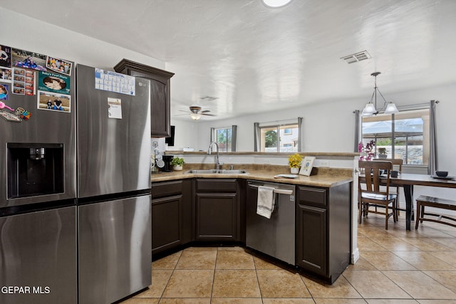 2709 Granite Rock Pl, El Paso, TX 79938 - kitchen featuring dark brown cabinets, light tile patterned flooring, appliances with stainless steel finishes, a sink, and visible vents