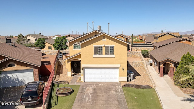 2709 Granite Rock Pl, El Paso, TX 79938 - view of front of house featuring a garage, stucco siding, driveway, and a residential view
