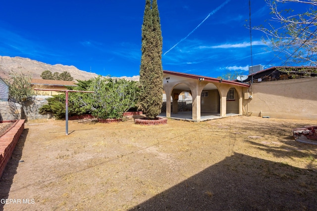 view of yard featuring a patio and a mountain view