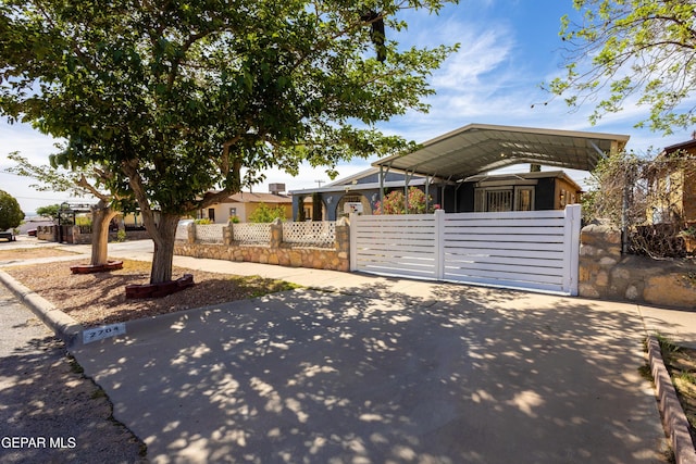 view of front of house featuring fence and a detached carport