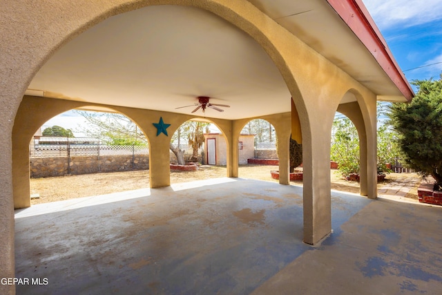 view of patio / terrace with ceiling fan and fence