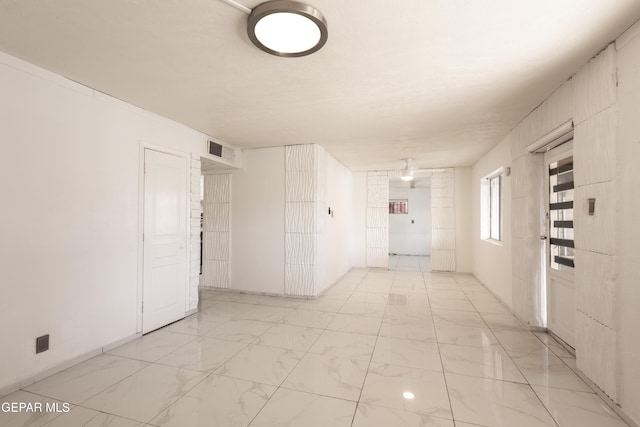 spare room with visible vents and marble finish floor
